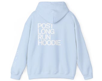 May include: A light blue hoodie with the text "POST LONG RUN HOODIE" printed on the back in white. The left sleeve has the text "26.2 -> 1DO" printed in white. The hoodie has a hood and long sleeves.