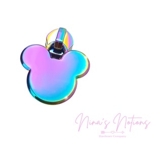 May include: A rainbow iridescent metal zipper pull with a Mickey Mouse shape.