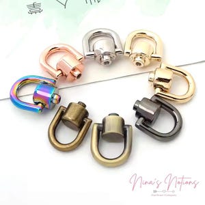 May include: Assortment of metal swivel hooks in various colors, including silver, gold, rose gold, rainbow, and black. The hooks are designed for attaching to bags, purses, or other accessories.