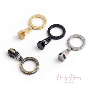 May include: Four metal zipper pulls in gold, black, and silver tones. Each pull features a circular ring with the text "MADE WITH LOVE JUST FOR YOU". The zipper pulls are for sewing and crafting projects.