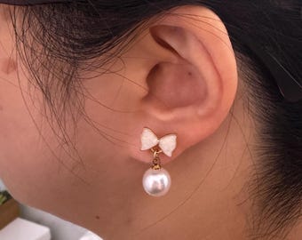 White Bow and Pearl Dangle Invisible Clip On Earrings