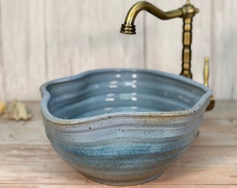 Amorphic small vessel sink, wobblily rustic light blue, table top wash basin.