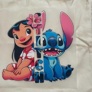 May include: A graphic featuring Lilo and Stitch from the Disney movie Lilo & Stitch. Lilo is wearing a red dress with white flowers and Stitch is blue. The word "Stitch" is vertically printed between the characters.