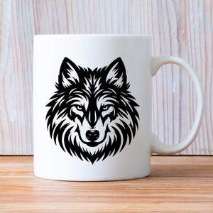 May include: White ceramic coffee mug with a black and white wolf head graphic.