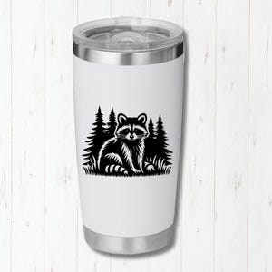 May include: White stainless steel tumbler with a black silhouette of a raccoon in a forest setting.