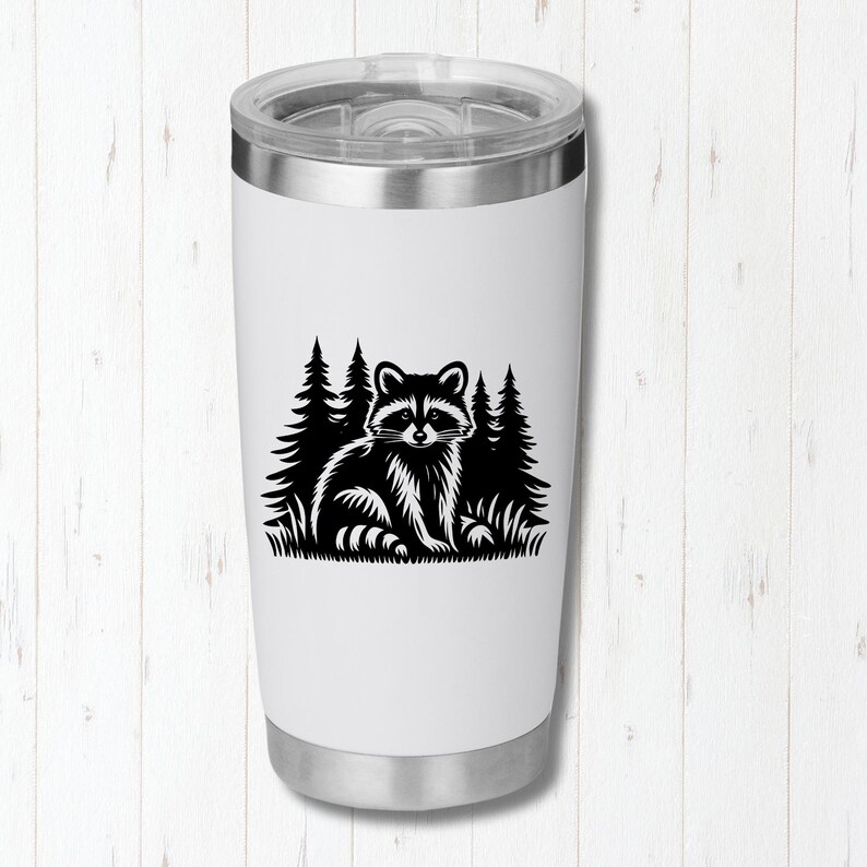 May include: White stainless steel tumbler with a black silhouette of a raccoon in a forest setting.