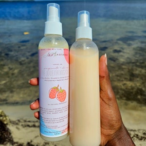 May include: Two clear plastic bottles of leave-in pomegranate and aloe rejuvenating hair mist with a pink label and strawberry illustrations. The label reads "A&M Naturals Leave-in Pomegranate & Aloe Rejuvenating Mist with Shea Butter, Strawberry Extract & Avocado Oil. Refreshing, Hydrating, Detangling. All Natural Ingredients. 8 fl oz / 236 ml."