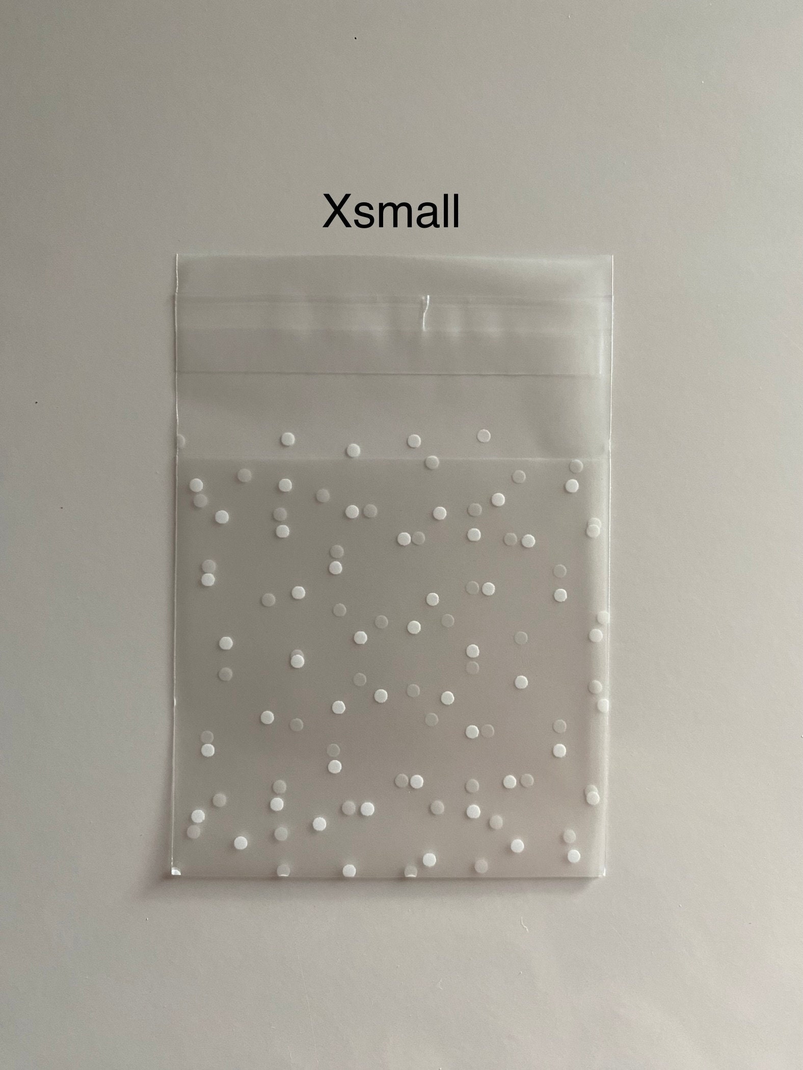 White polka dot pattern clear self adhesive bags (XXS/XS/S/M/L/LS) pack of 10,25,50,100,200,500. Ideal for party favours, gift bags.