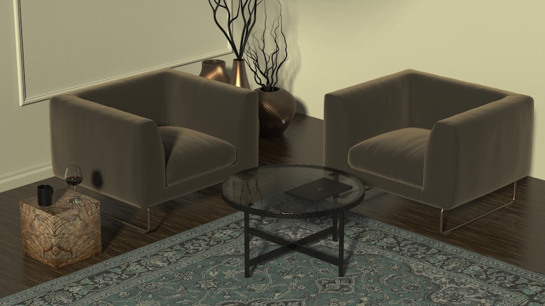 May include: Two brown velvet armchairs with metal legs face each other across a glass-top coffee table with a black metal frame. A small wooden side table with a patterned surface sits next to one of the chairs. A blue and green patterned rug covers the floor.