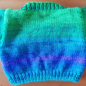May include: A hand-knitted sweater in a gradient of green, blue, and purple.