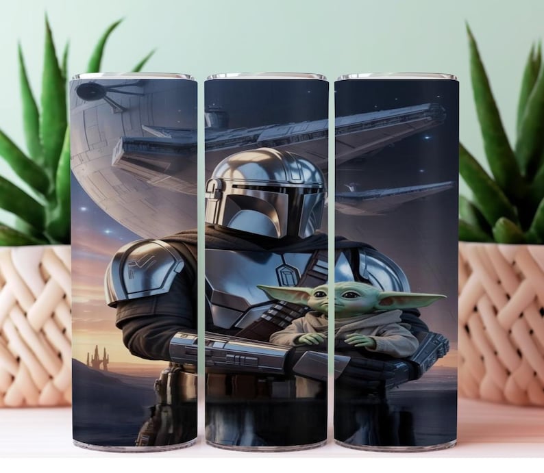 May include: A stainless steel tumbler featuring a detailed illustration of The Mandalorian holding Grogu, with a spaceship and a planet in the background. The artwork is set against a dark, space-themed backdrop, with a sunset-colored horizon.