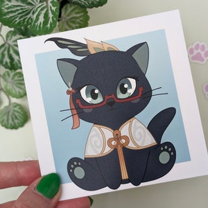 May include: A black cat wearing red glasses and a white and gold patterned robe. The cat has a feather on its head and is sitting on a light blue background.