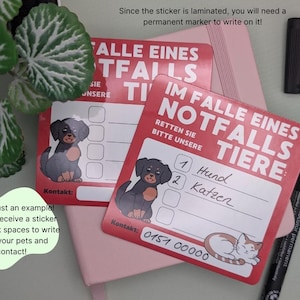 May include: Red laminated stickers with German text, featuring a dog and cat illustration, designed for emergency pet contact information. Includes a black permanent marker and a pink notebook.