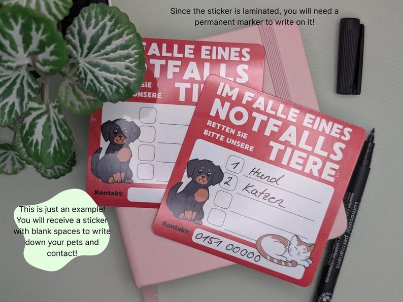 May include: Red laminated stickers with German text, featuring a dog and cat illustration, designed for emergency pet contact information. Includes a black permanent marker and a pink notebook.