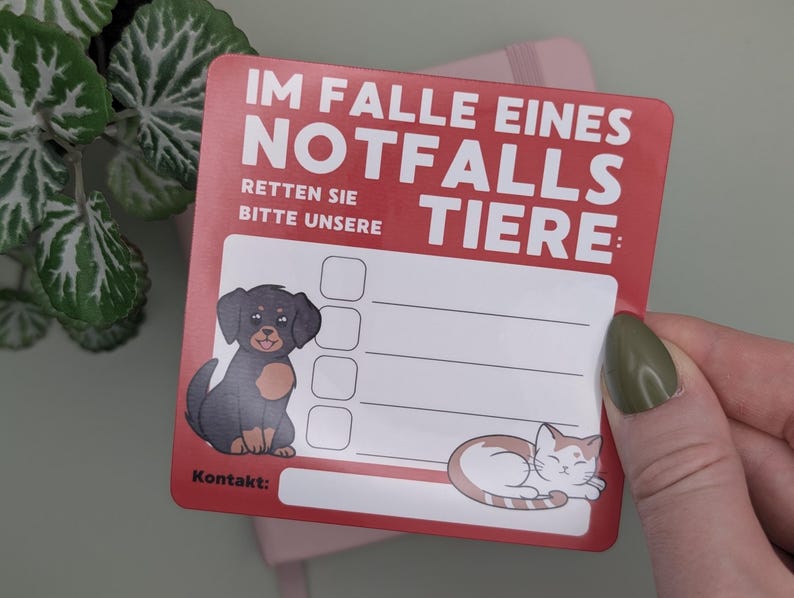 May include: A red and white pet emergency contact card with the text "IM FALLE EINES NOTFALLS RETTEN SIE BITTE UNSERE TIERE:" and illustrations of a dog and a cat. Includes space for contact information.