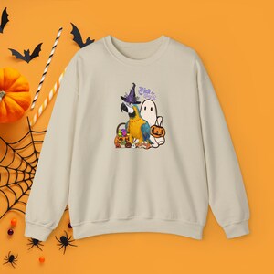 macaw donning a witch hat Trick or treat Halloween Unisex Heavy Blend™ Crewneck Sweatshirt, yellow blue macaw pullover for macaw mom