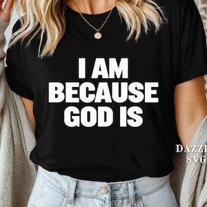 May include: Black t-shirt with the white text "I AM BECAUSE GOD IS". The shirt has short sleeves and a crew neck. The text is centered on the front of the shirt. The brand name "DAZZLE SVG" is printed on the lower right side of the shirt.