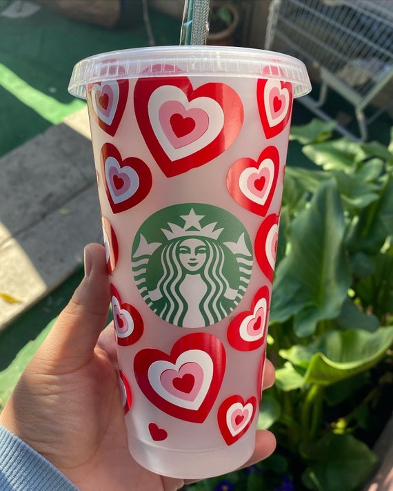 Pink starbucks cup with yellow straws on Craiyon