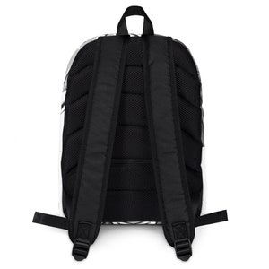 May include: Black backpack with a white and grey pattern. The backpack has a mesh back panel and adjustable straps.