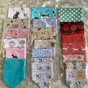 May include: A collection of 18 dog bandana designs, featuring various patterns and colours, including polka dots, stripes, and animal prints. The bandanas are arranged in rows and numbered 1 through 18.