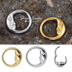 Puede incluir: Joyas plateadas y doradas en forma de media luna. Las joyas presentan un diseño detallado de rostro. El texto "Shine Jewelry" es visible en la imagen. Las joyas se muestran desde varios ángulos.