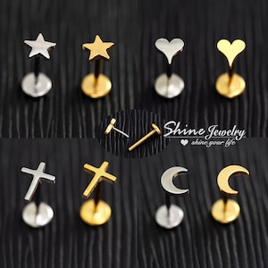 May include: A selection of stud earrings in silver and gold colours, showcasing star, heart, cross, and crescent moon designs. The earrings are presented against a black backdrop. The text "Shine Jewelry shine your life" is also visible.