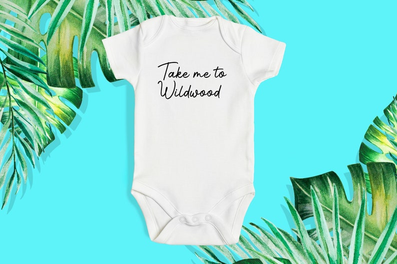 May include: White baby onesie with black text that reads "Take me to Wildwood".
