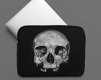 May include: Black laptop sleeve with a white and gray skull illustration. The skull is drawn in a realistic style and has a detailed texture. The text "Before Crypt" is written on the skull.