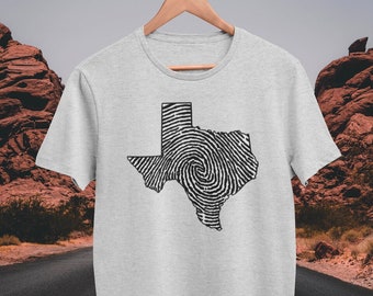 May include: A grey t-shirt with a black and white outline of the state of Texas. The outline is filled with a fingerprint pattern.