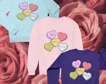 May include: Three sweatshirts with different colors and designs. The sweatshirts feature a graphic of candy hearts with the words "DNA", "Blood Stains", "Forensics", "Latent Prints", and "Ballistics" on them.