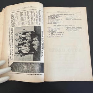 May include: Open book with pages featuring text and a black and white photograph of a group of people. The left page has text about the North Carolina State Fair 1939. A ribbon reads "First Premium North Carolina State Fair 1939."
