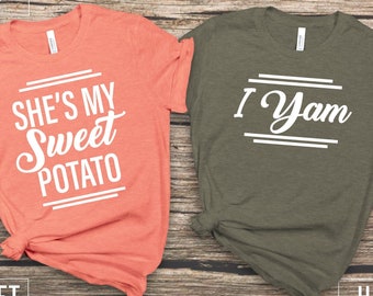 Könnte beinhalten: Zwei T-Shirts mit einem passenden Partner-Design. Das korallenfarbene Shirt sagt "She's my sweet potato" und das olivgrüne Shirt sagt "I yam".