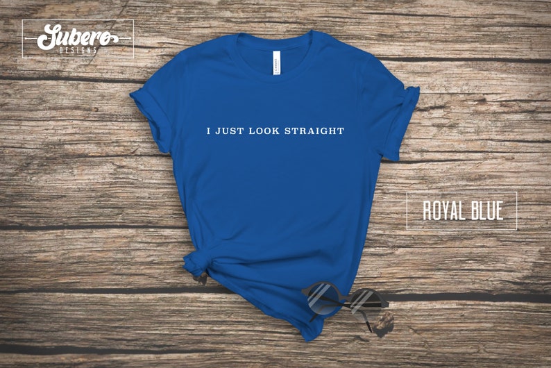 May include: Royal blue t-shirt with the text "I just look straight" printed in white on the front.