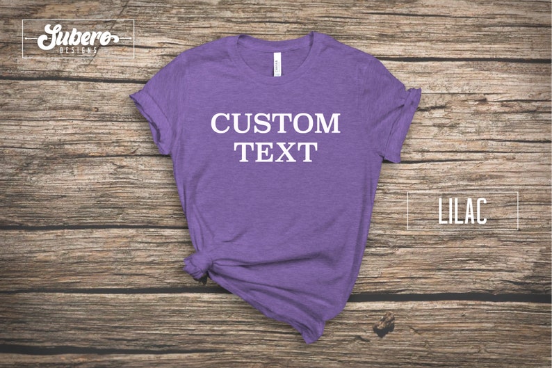 May include: A lilac t-shirt with the text "CUSTOM TEXT" printed in white on the front.
