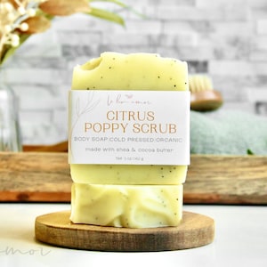 May include: A bar of citrus poppy scrub soap with a white label that reads "Citrus Poppy Scrub" and "Body Soap Cold Pressed Organic made with shea & cocoa butter".