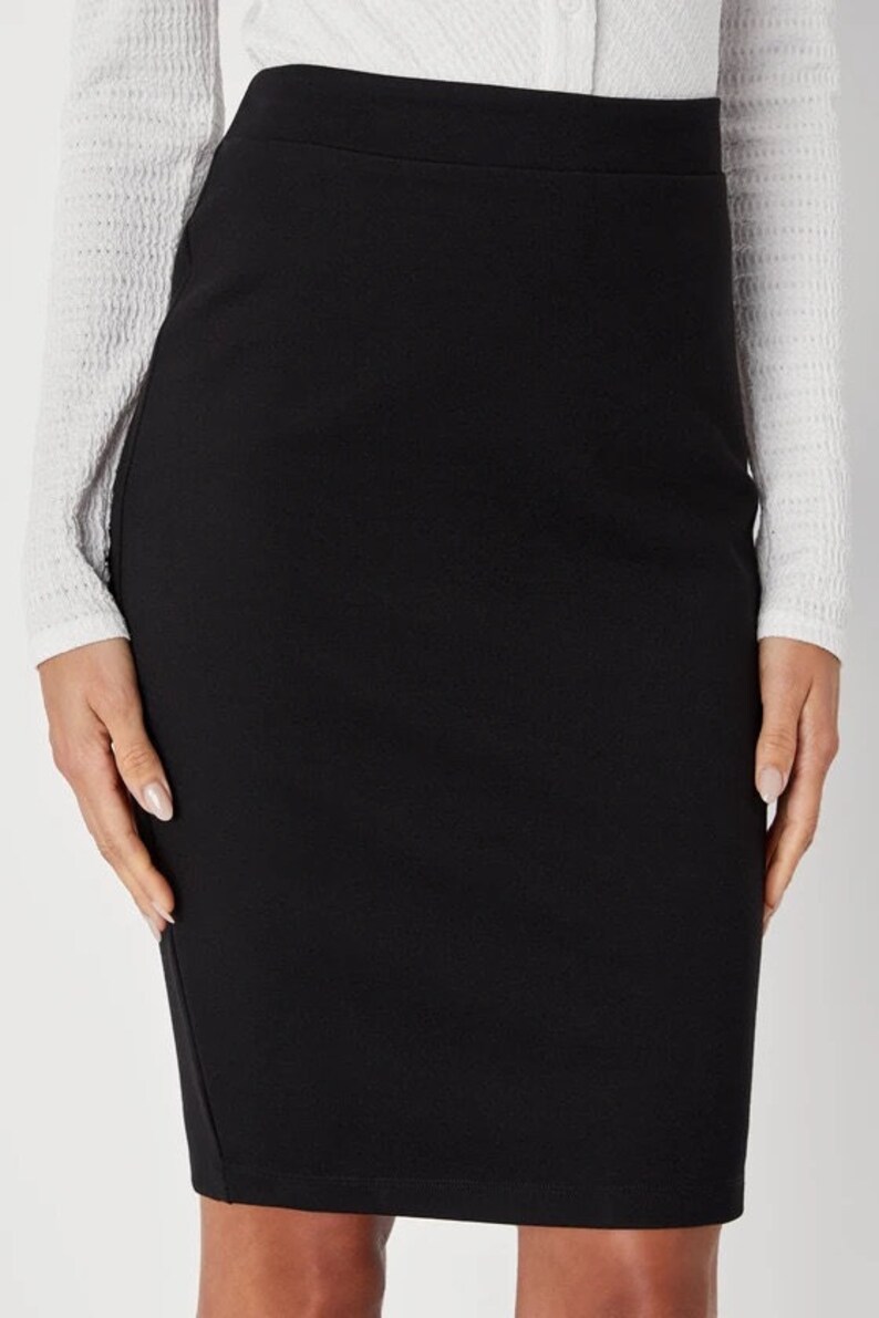 May include: A black pencil skirt with a straight, fitted silhouette. The skirt is made of a smooth, stretchy fabric.