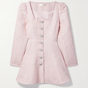 May include: A pink, long-sleeved dress with a square neckline and a button-up front. The dress has a fitted bodice and a flared skirt. The buttons are silver with a sparkly finish.