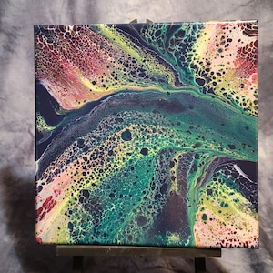 May include: Abstract painting on canvas with swirling green, yellow, and red colors. The painting has a textured surface with small, round bubbles.