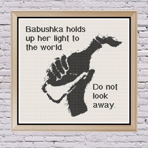 May include: Black and white illustration of a hand holding a bottle with the text "Babushka holds up her light to the world. Do not look away."