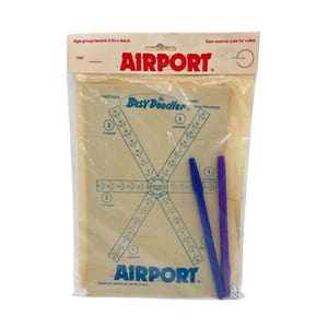 May include: A vintage Airport Busy Doodler game in original plastic packaging. The set includes a tan game board with blue printed graphics of an airport runway layout, two blue plastic pens, and a small white die with black pips.