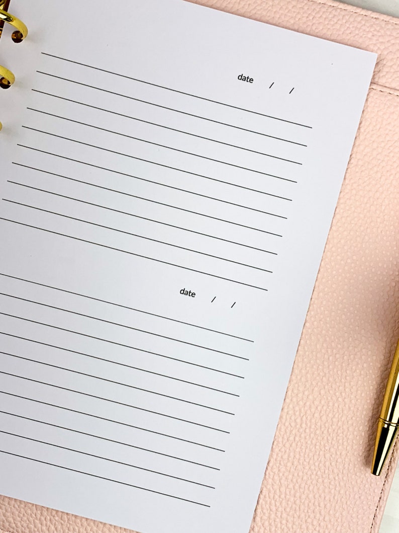 May include: A white planner with lined pages and the word "date" written at the top of each page.