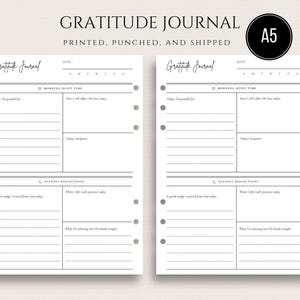 May include: A5-sized gratitude journal with a minimalist design. The journal features lined pages for daily reflections, with prompts for morning and evening entries. The cover reads "Gratitude Journal" in elegant script.