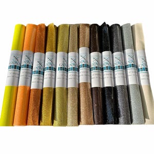Puede incluir: Doce rollos de tela de vinilo con purpurina de 30,5 cm de largo en varios colores, incluidos amarillo, naranja, dorado, marr&oacute;n, negro, plateado y blanco. Cada rollo tiene una etiqueta con el texto "Wonder & Goodie" y "12" Vinyl Roll.