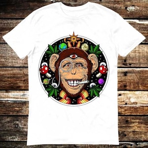 May include: White t-shirt with a psychedelic design featuring a monkey with a third eye, a monocle, and a joint in its mouth. The monkey is surrounded by planets, stars, mushrooms, and marijuana leaves.