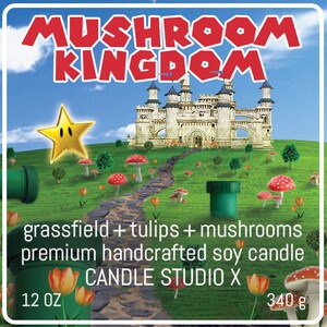 May include: A green, white, and red candle with a mushroom kingdom theme. The candle is 12 oz and features a castle, mushrooms, and tulips. The text on the label reads "grassfield + tulips + mushrooms premium handcrafted soy candle CANDLE STUDIO X 12 OZ 340 g".