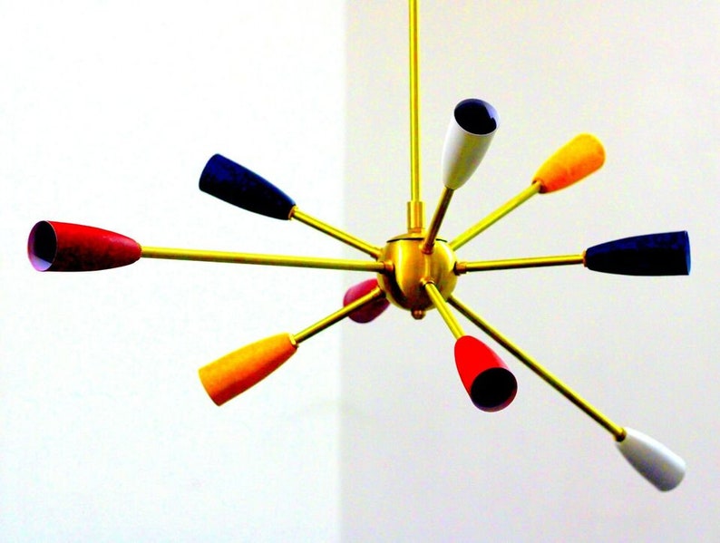 May include: A gold-coloured, multi-armed chandelier with eight colourful glass shades. The shades are red, yellow, white, and blue.