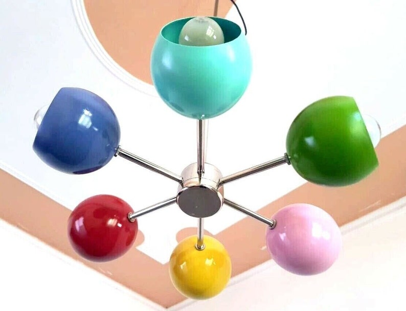 May include: A six-light chrome chandelier with colorful globe-shaped shades. The shades are blue, green, yellow, pink, red, and turquoise.