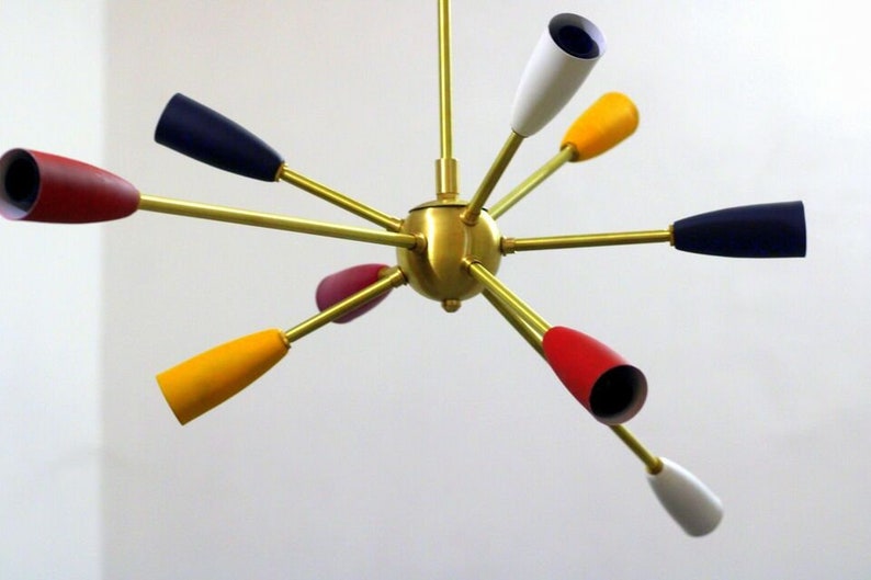 May include: A brass chandelier with eight colourful shades. The shades are red, yellow, blue and white.