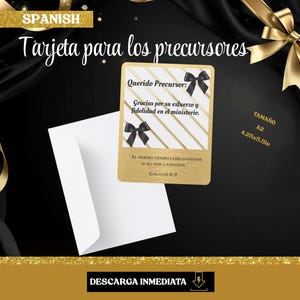 Op de afbeelding: Een goudkleurige kaart met zwarte strikken en Spaanse tekst, 'Tarjeta para los precursores'. De kaart wordt vergezeld door een witte envelop en staat tegen een zwarte achtergrond met gouden linten. De kaart is 10,8 x 14 cm groot.