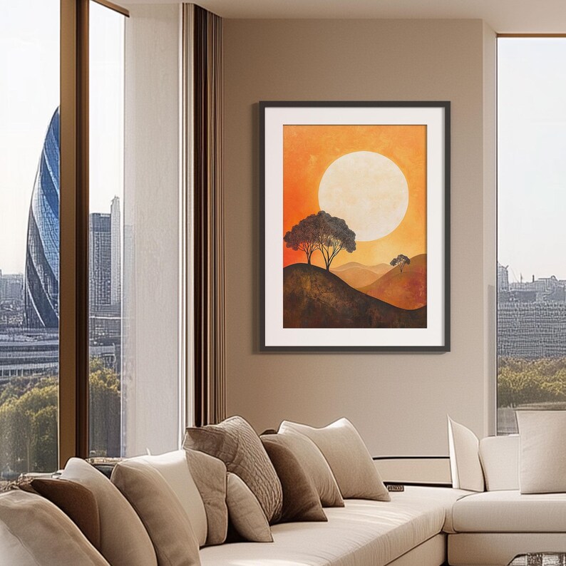 May include: A framed painting of a sunset landscape with two trees silhouetted against a large, bright orange sun. The sky is a gradient of orange and yellow, and the hills are a dark brown.